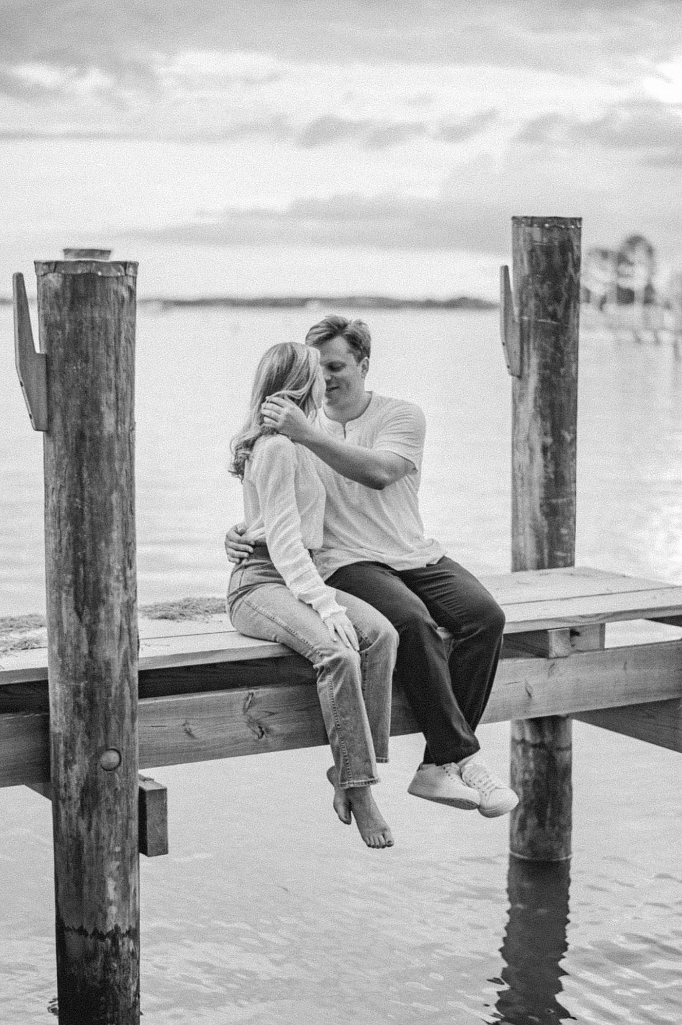 A couple on a dock for their Classic Americana Ralph-Lauren-inspired engagement photo