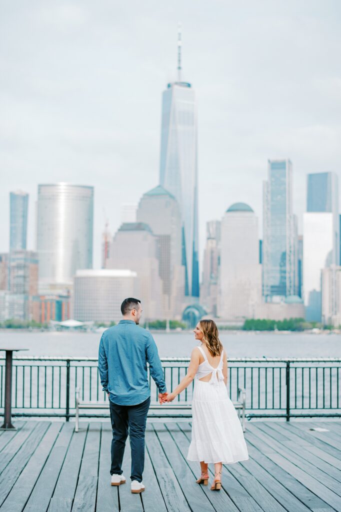 A couple holding hands during their Jersey City Waterfront engagement session photo