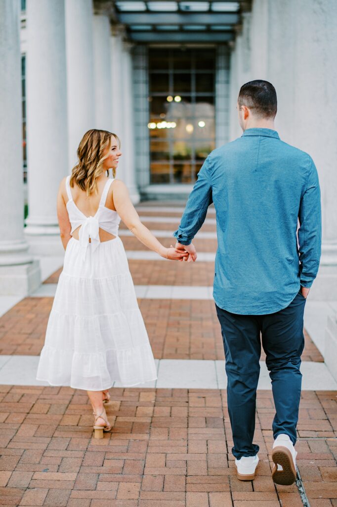 A couple holding hands during their Jersey City Waterfront engagement session photo