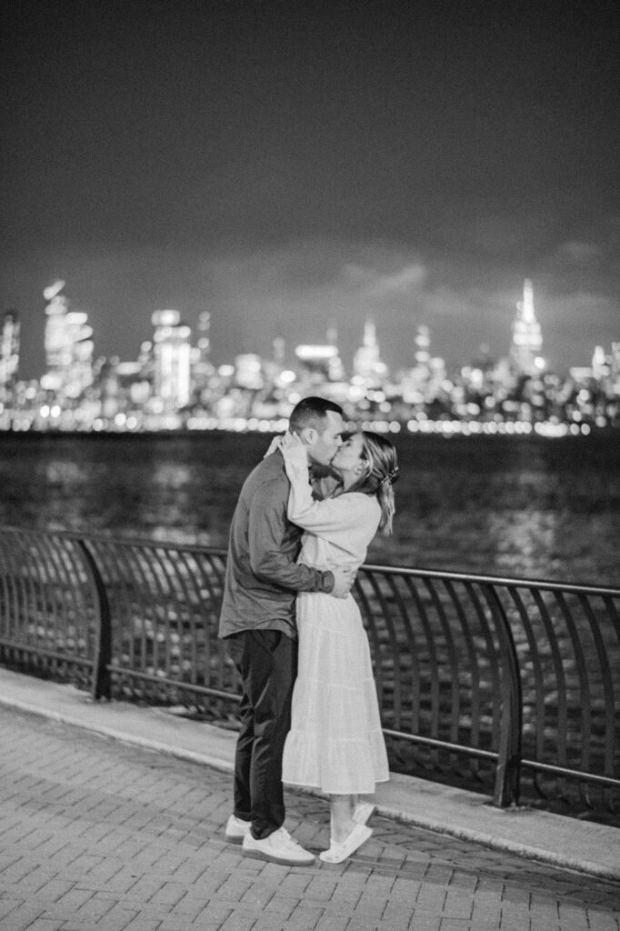 A couple sharing a kiss during their Jersey City Waterfront engagement session photo