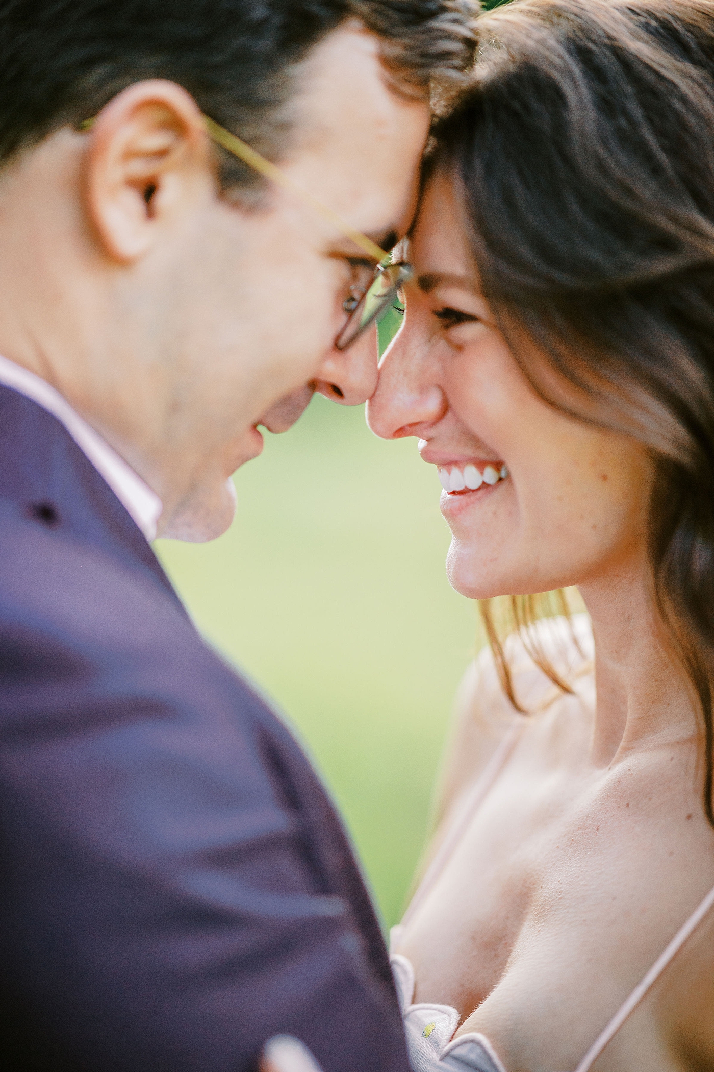Elegant spring engagement session in Washington, DC featuring a couple walking together in soft natural light with fresh greenery in bloom.