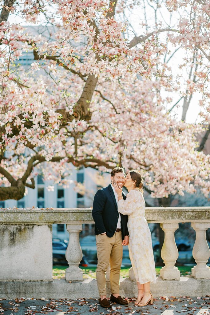 East Coast spring engagement session with a stylish couple photographed in natural light among early spring foliage.
