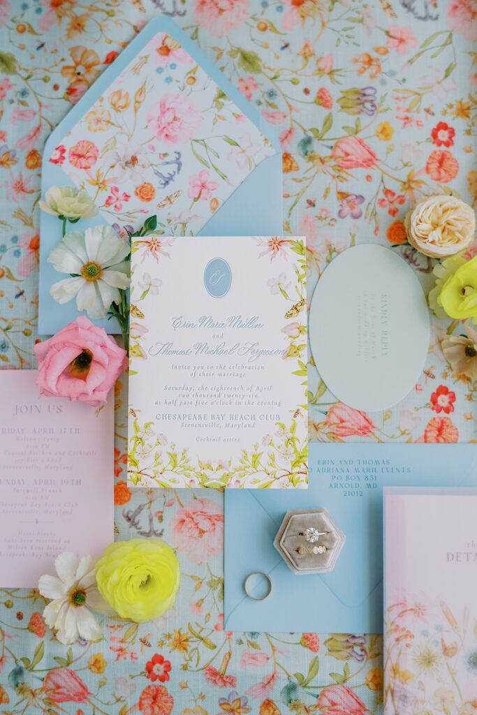 Pastel floral wedding invitation suite with blue envelopes and garden-inspired details designed by Kelsey Malie