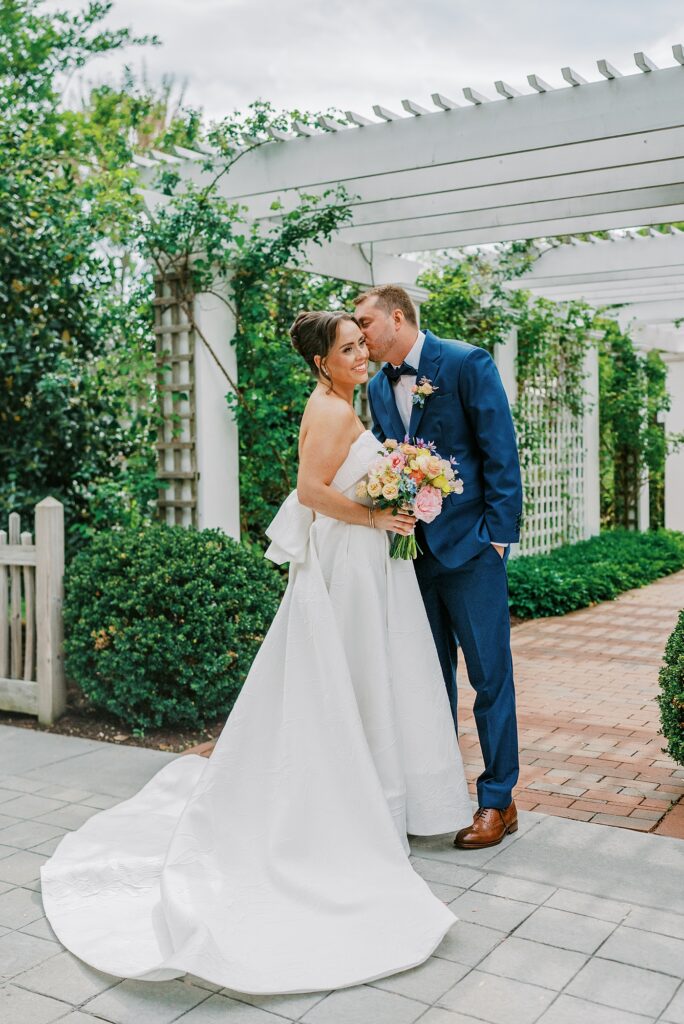 Bride and groom portraits under garden pergola at Chesapeake Bay Beach Club
