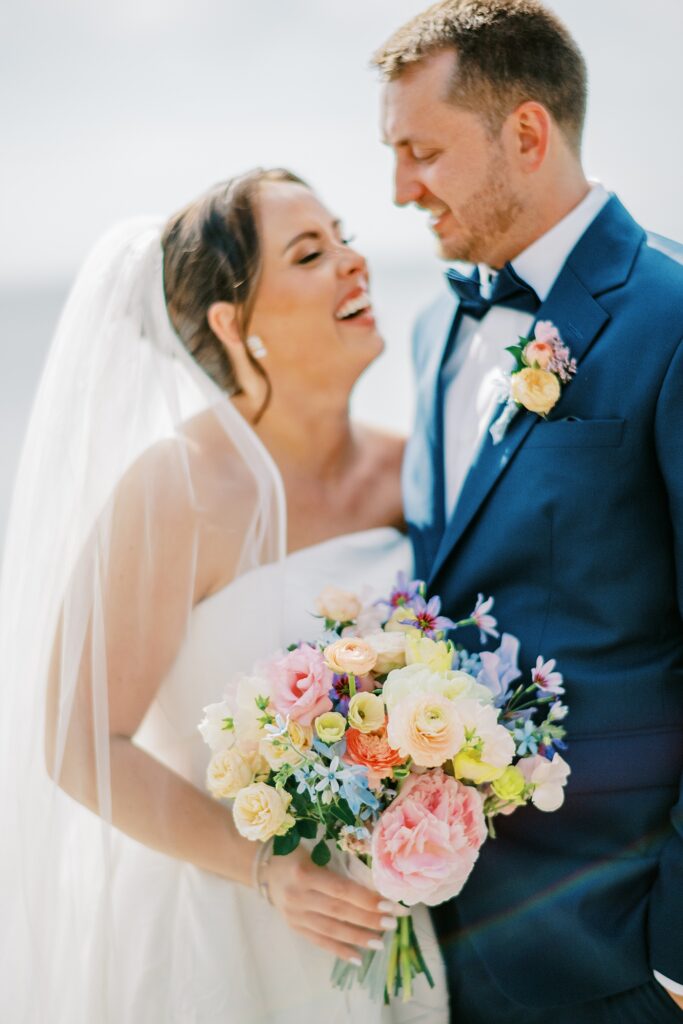 Romantic close-up of bride and groom with pastel bouquet on wedding day
