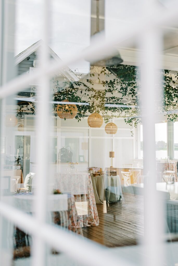 Cocktail Hour space with greenery installation and woven lanterns at Chesapeake Bay Beach Club